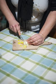 woman's hands with ring cut vegetables on the kitchen cutting board