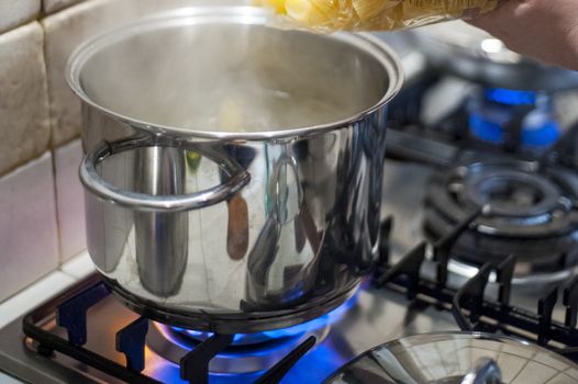 throw pasta into the pot of water on the stove fire