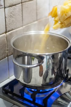 throw pasta into the pot of water on the stove fire
