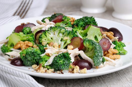 Dietary broccoli salad with chicken, sliced grapes, crushed nuts and yoghurt dressing