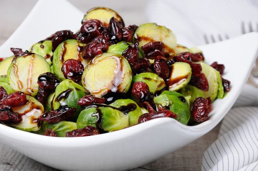 Salad from Brussels sprouts with dried cranberries under balsamic sauce