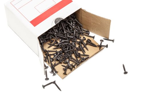 group of black screws for fixing drywall on metal profiles, in a paper box
