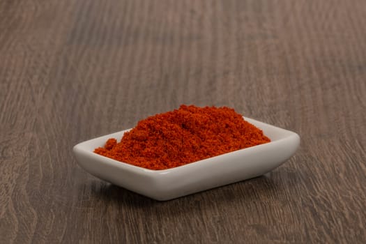 Bowl of ground red pepper spice in bowl.