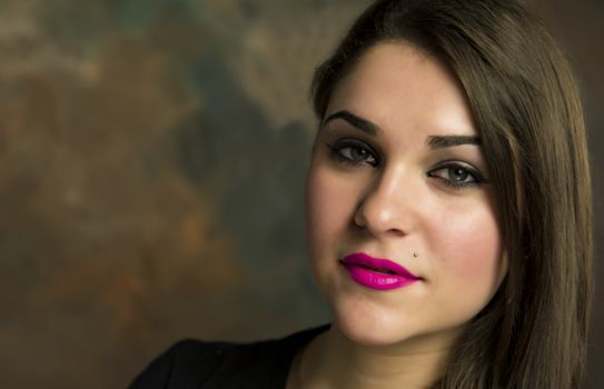 beautiful young woman in her 20s in a close-up portrait in studio