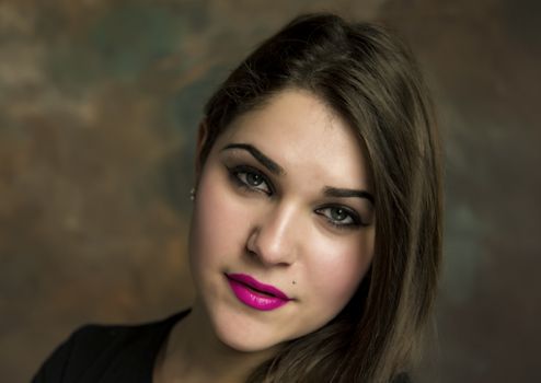 beautiful young woman in her 20s in a close-up portrait in studio