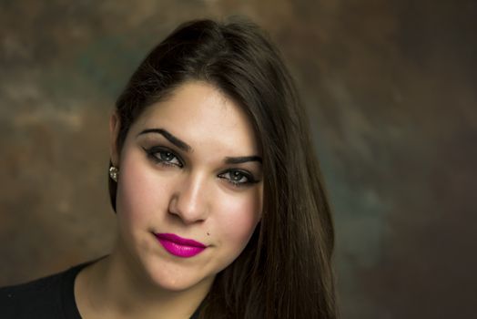 beautiful young woman in her 20s in a close-up portrait in studio