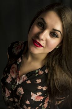 beautiful young woman in her 20s in a close-up portrait in studio