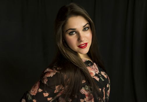 beautiful young woman in her 20s in a close-up portrait in studio