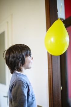 child looks happy balloon for birthday party in his home