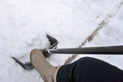 Woman Shoveling snow on street 