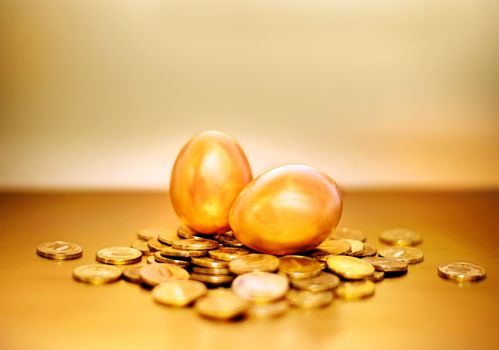Gold coins and golden eggs, the concept of financial growth.