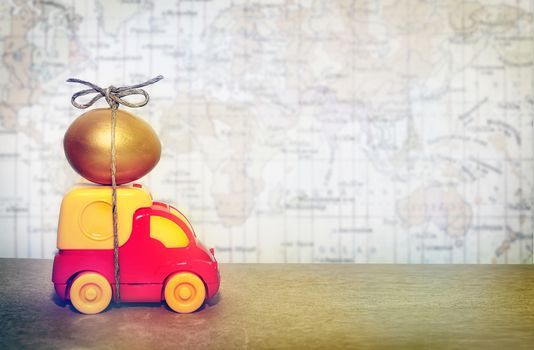 A toy truck carrying a golden egg, a symbol of the reliability of delivery of postal goods.