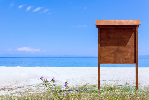 sign board on an empty beach near the ocean