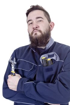 Bearded young man with a wrench in a working overall