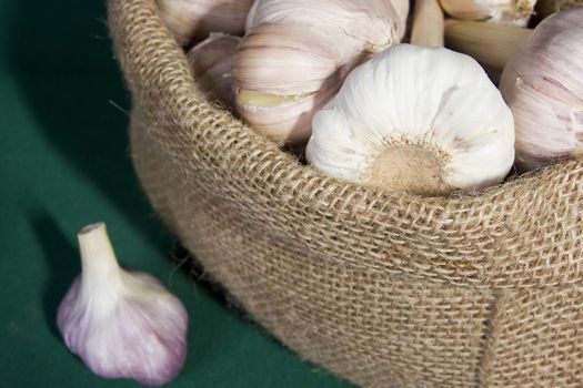 Garlic in a bag on a green background