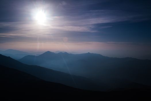 nature scenery, the sun and mountain silhouettes