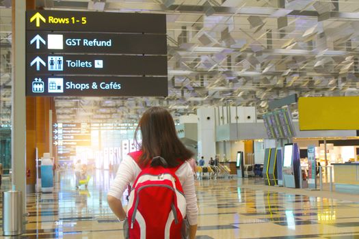 Girl with backpack traveling in the airport