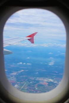 Earth and plane wing view from plane window