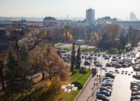 A panoramic view of sofia downtown with yellow pavement and garden infront of the National theatre.