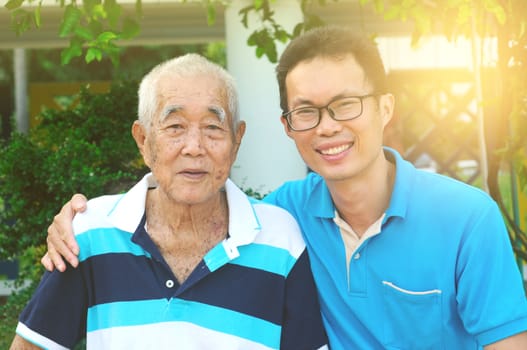 Happy asian family relaxing in the garden.Senior man smiling.