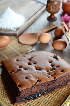 Taiwanese  chocolate sponge cake with bamboo weaving basket on wooden board