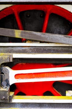 red and white wheel of an old historic steam train on rail