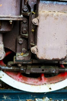 red and white wheel of an old historic steam train on rail