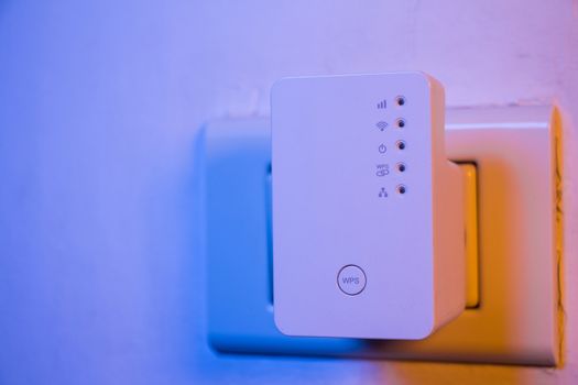 WiFi repeater in electrical socket on the wall. Device that help to extend wireless network in home or office.