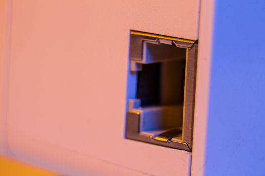 Macro closeup on WiFi repeater ethernet socket. The device is in electrical socket on the wall. It help to extend wireless network in home or office.