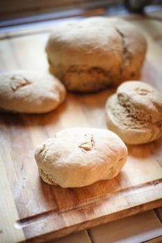 Homemade whole wheat bread with organic sourdough, wooden background