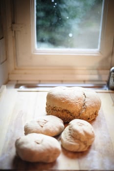 Homemade whole wheat bread with organic sourdough, wooden background