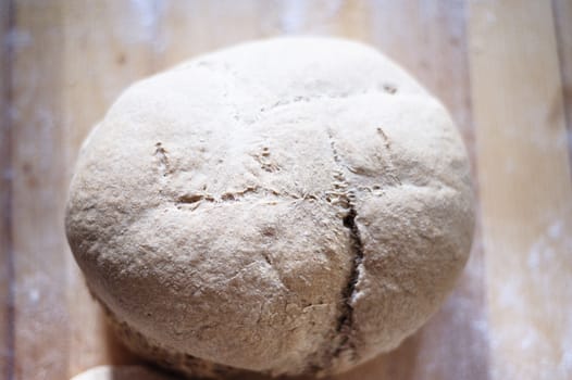 Homemade whole wheat bread with organic sourdough, wooden background