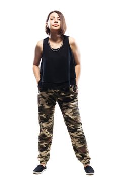 girl in camouflage pants standing against white background