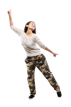 girl in camouflage pants dancing against white background