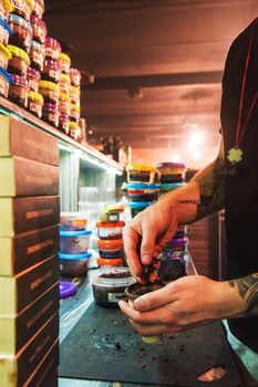 Shisha hookah preparing by barman. Bartender lays tobacco for smoking in hookah