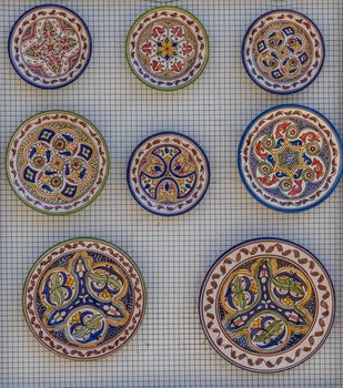 China decorations on a plate on a wall in the city of Ronda Spain, Europe on a hot summer day with clear blue skies