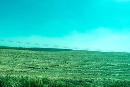 Greenery, Mountains, Farms and Fields on the outskirts of Ronda Spain, Europe on a hot summer day with clear blue skies