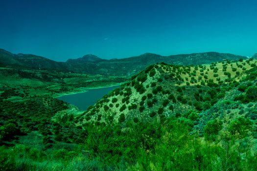 Greenery, Mountains, Farms and Fields on the outskirts of Ronda Spain, Europe on a hot summer day with clear blue skies