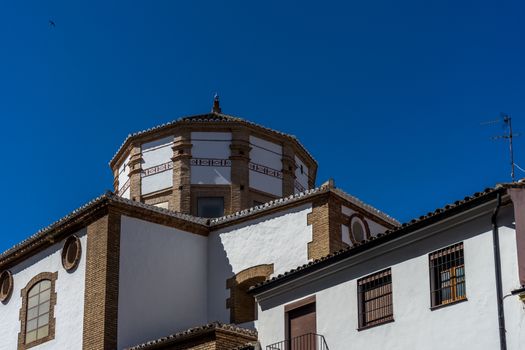 A church in the city of of Ronda Spain, Europe on a hot summer day with clear blue skies