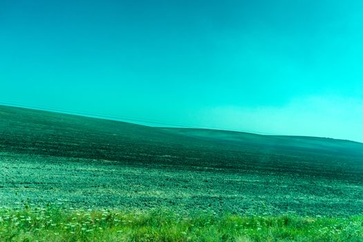 Greenery, Mountains, Farms and Fields on the outskirts of Ronda Spain, Europe on a hot summer day with clear blue skies