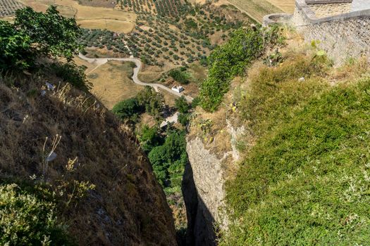 A gorge in the city of Ronda Spain, Europe on a hot summer day with clear blue skies