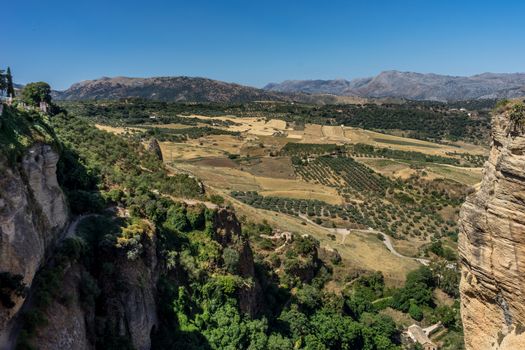A gorge in the city of Ronda Spain, Europe on a hot summer day with clear blue skies