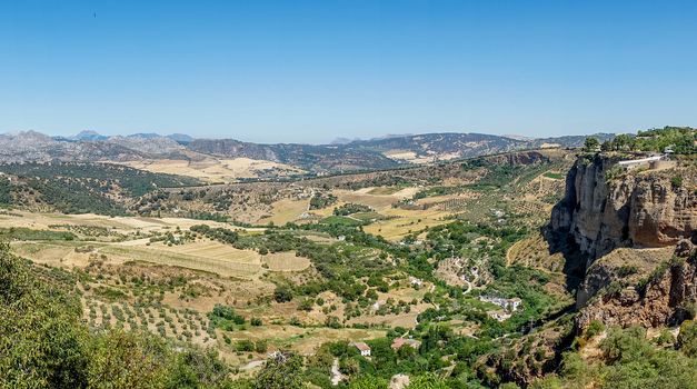 Greenery, Mountains, Farms and Fields on the outskirts of Ronda Spain, Europe on a hot summer day with clear blue skies