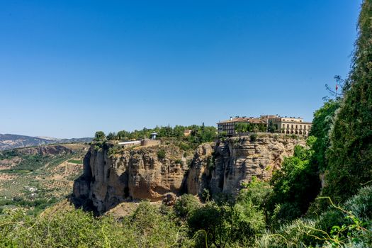 A gorge in the city of Ronda Spain, Europe on a hot summer day with clear blue skies