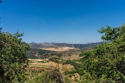 A gorge in the city of Ronda Spain, Europe on a hot summer day with clear blue skies