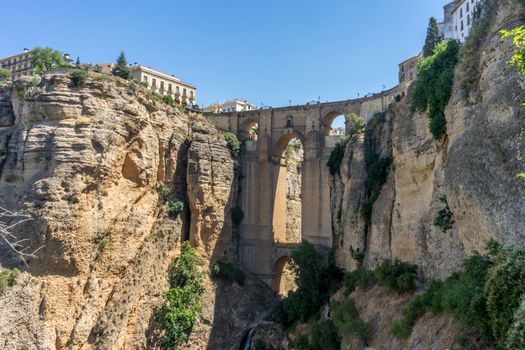 A gorge in the city of Ronda Spain, Europe on a hot summer day with clear blue skies