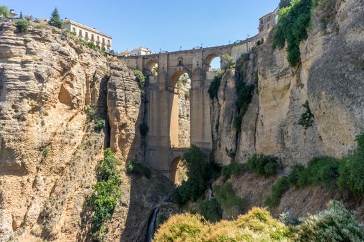 A gorge in the city of Ronda Spain, Europe on a hot summer day with clear blue skies