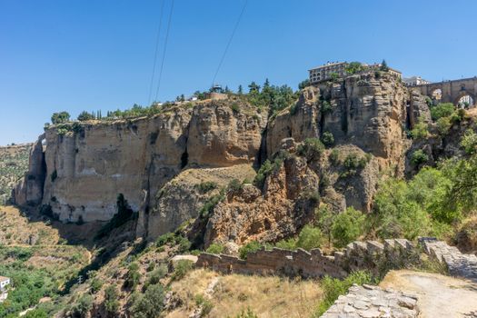 A gorge in the city of Ronda Spain, Europe on a hot summer day with clear blue skies