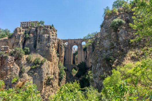 A gorge in the city of Ronda Spain, Europe on a hot summer day with clear blue skies