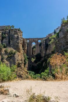 A gorge in the city of Ronda Spain, Europe on a hot summer day with clear blue skies